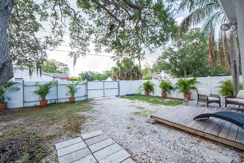 view of closed gate.  Several cars can fit in backyard