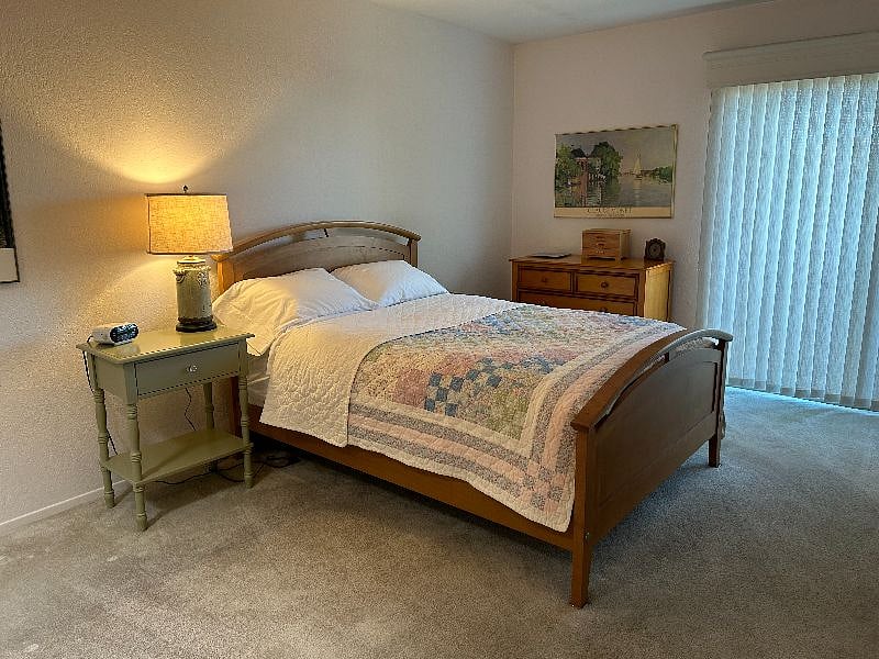 Master bedroom with full bed and walk in closet, access to patio