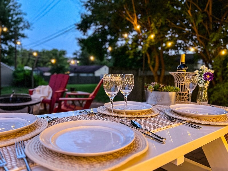 Table runner and serving utensils are included for use with the listing