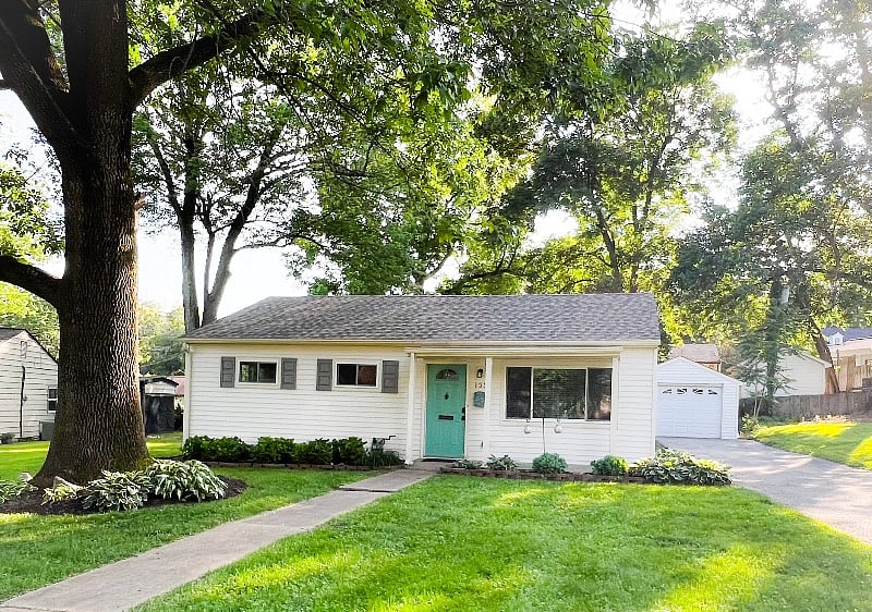 Front of house, large driveway and garage
