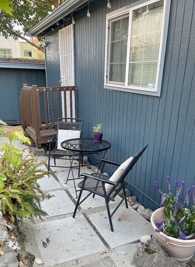 Back yard with string lights along the roof line.