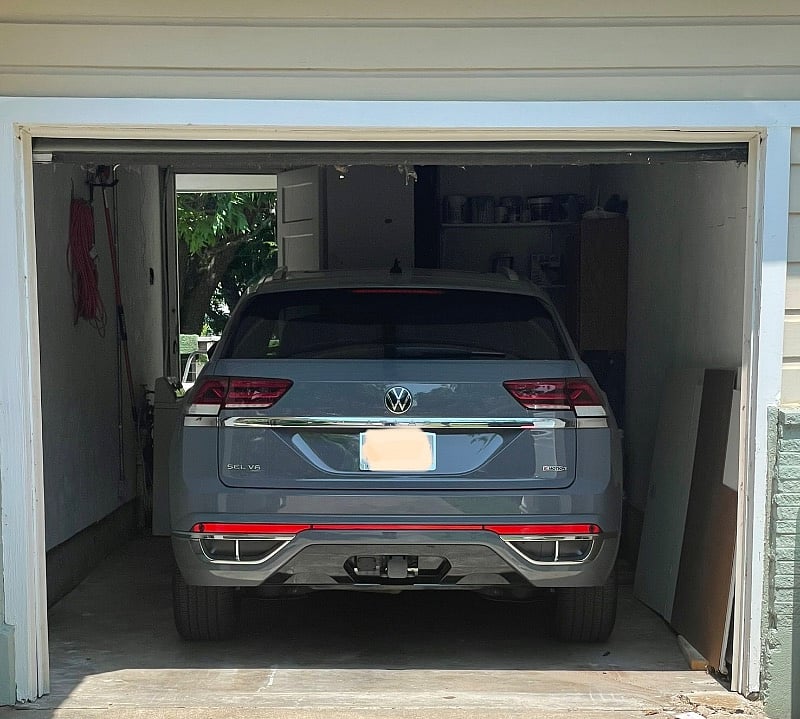 Single car garage pictured with full size SUV.