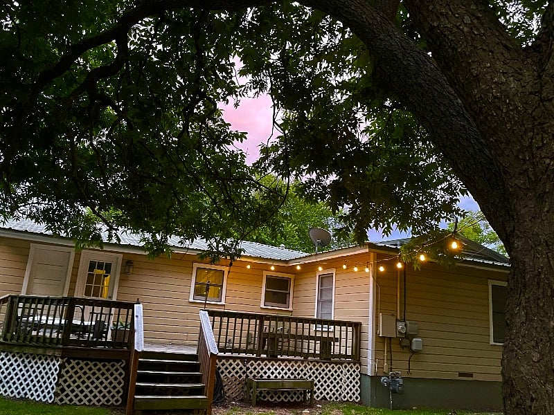 Backyard deck with string lighting is perfect for a relaxing evening after work.