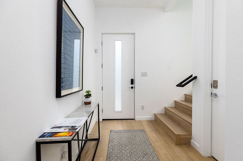 Bedroom Hallway & Front Door.  Stairs up to Dining, Living & Kitchen.