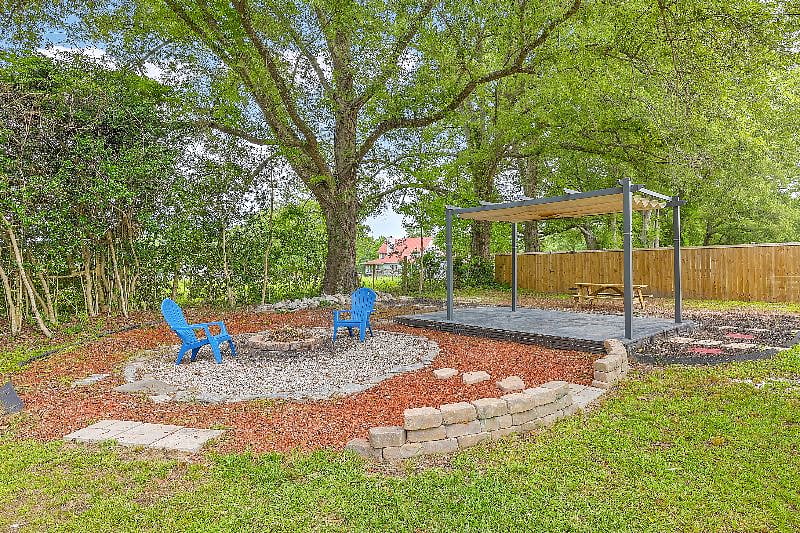 Fire pit, picnic table, and pergola by the neighboring horse farm. 