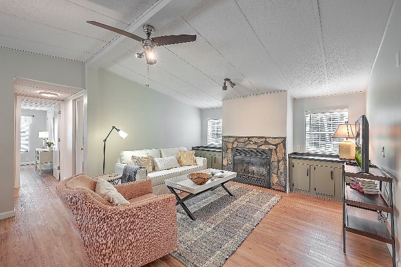 Living room towards hallway and two additional bedrooms.