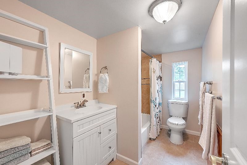 Second bathroom with tiled tub and shower. 