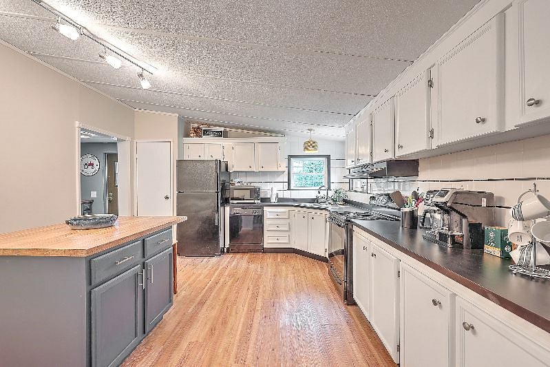 Large kitchen and island with plenty of cabinet space. 