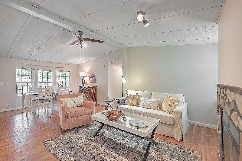 Living room with comfortable sofa and swivel barrel chair.