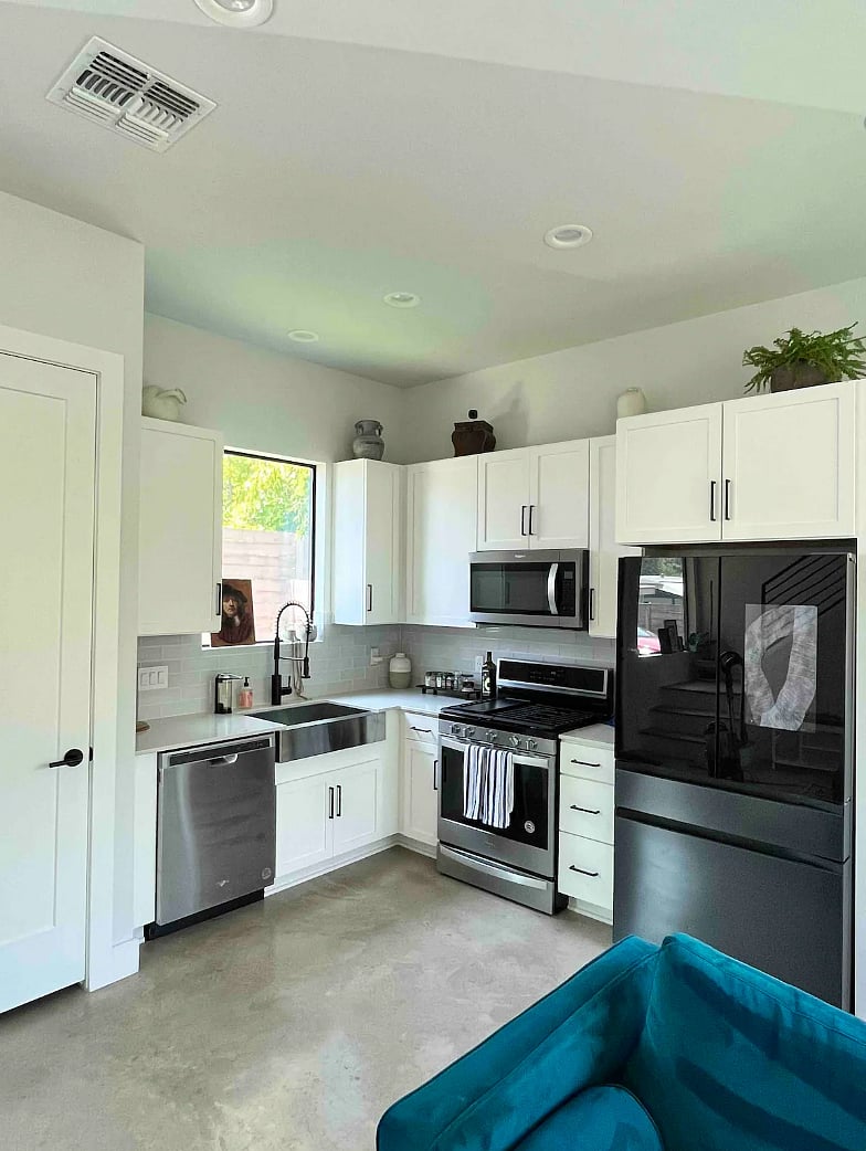 Complete kitchen with modern appliances, including a smart fridge with a built-in water filter.