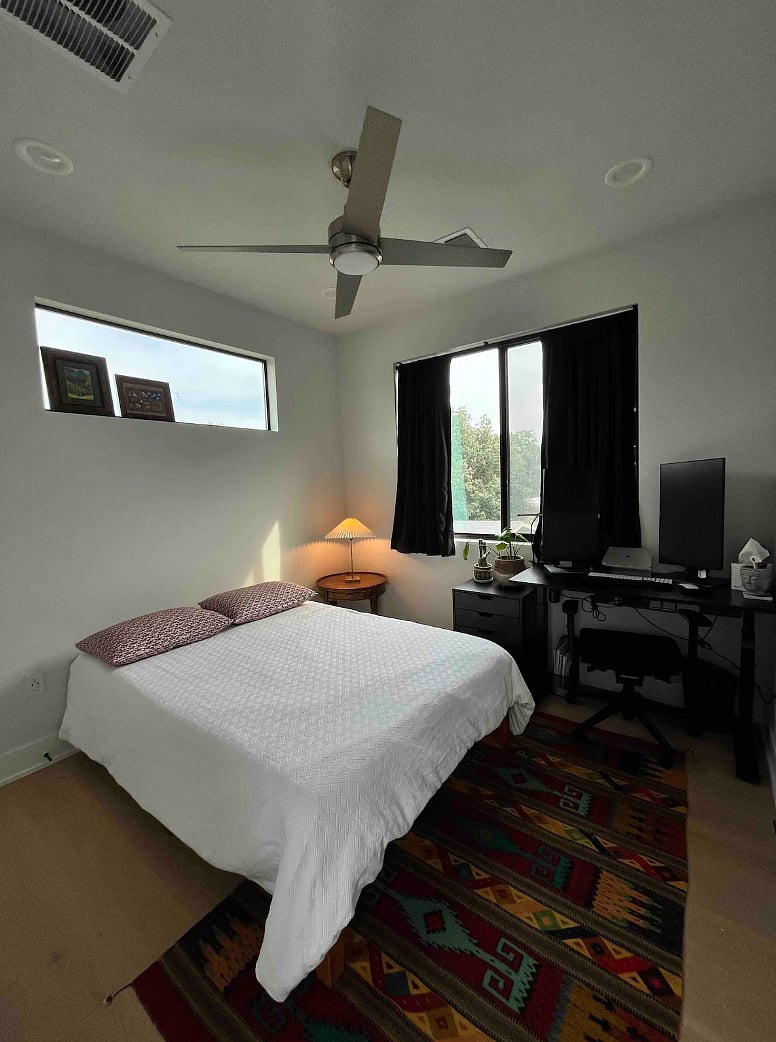 Second bedroom, full sized bed, desk and blackout curtains.
