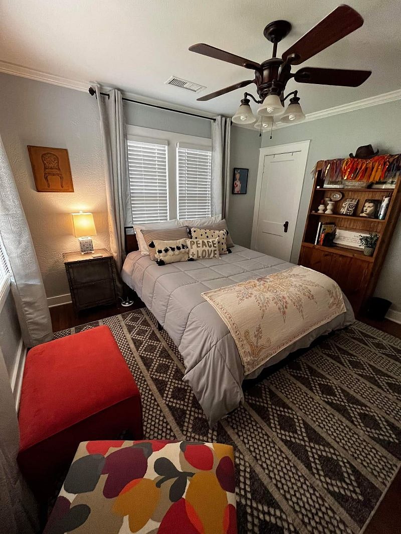 bedroom #1 at front of house with large window, black out curtains and blinds 