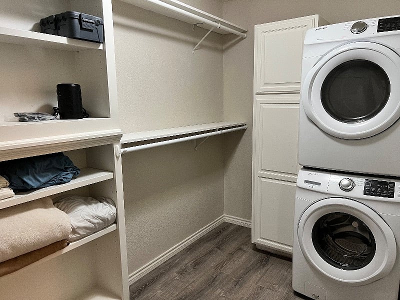 Basement walk in closet with washer/dryer