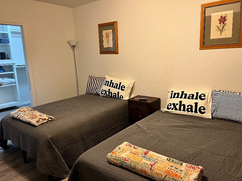 Basement bedroom with 2 double beds, TV and walk in closet