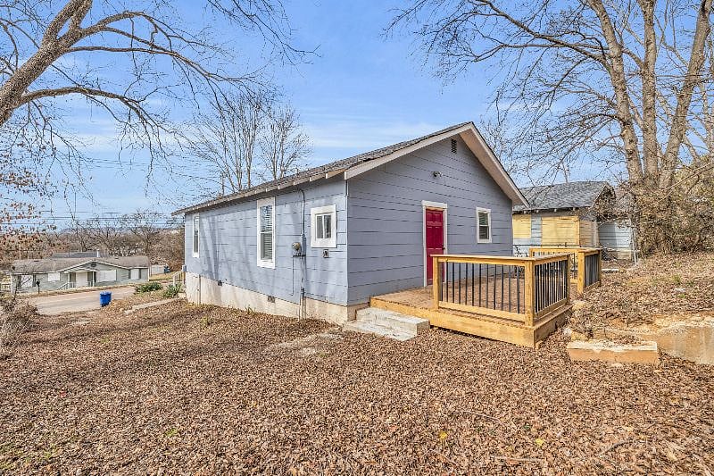 Side of the home/back porch and yard