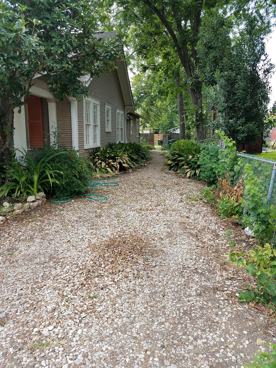 view of side yard to the back door of duplex entrance