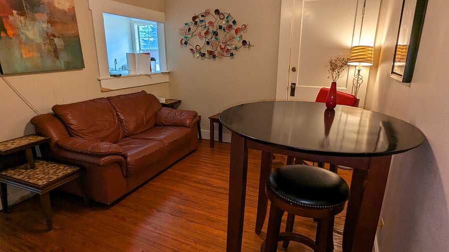 Living room with seating and bistro table for dining.