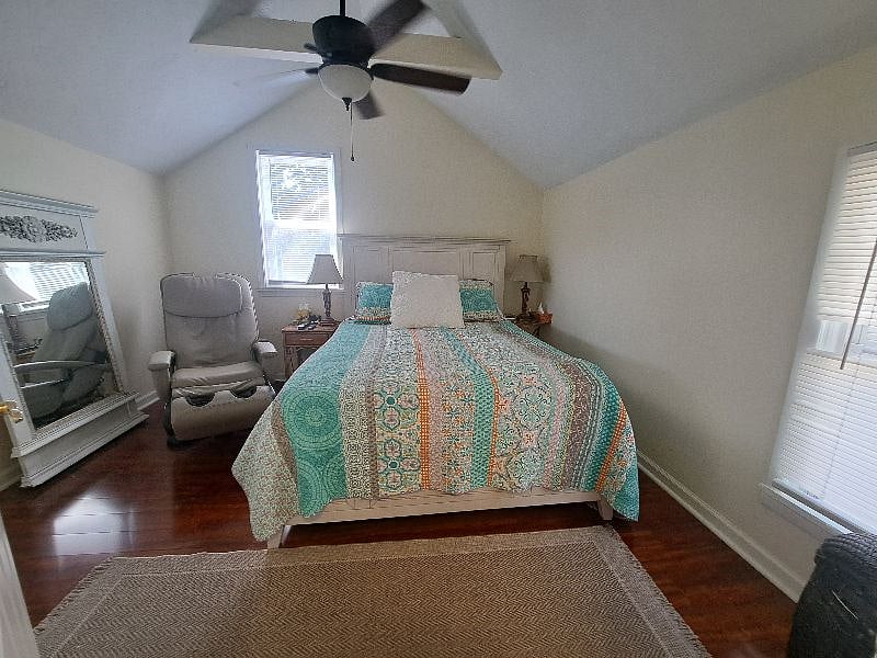 Master bedroom with massage chair and walk in closet.