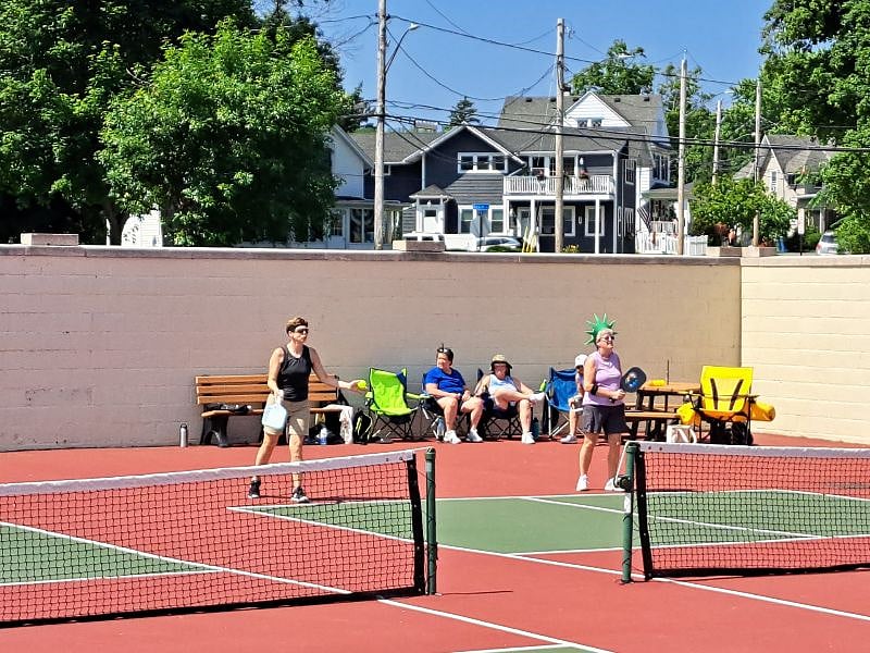 Beachside pickleball court with our home in the back round