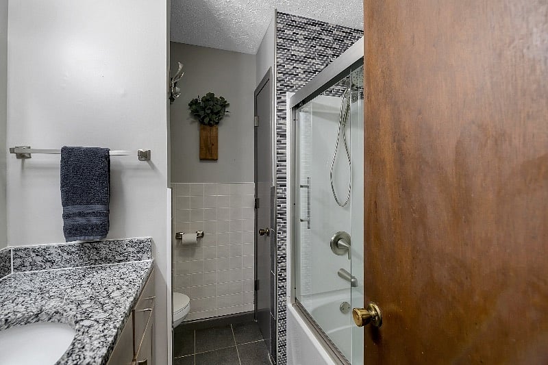 Bath and shower with upgraded Moen Shower with magnetic hand held shower head. -bath closet has a large shelf for each bedroom labeled.