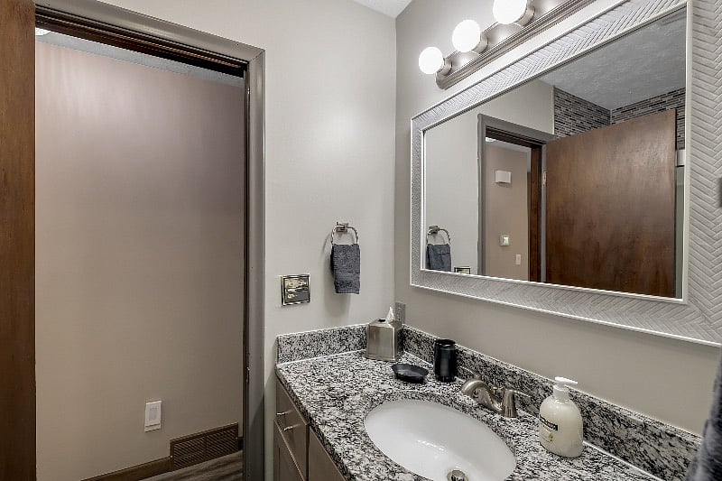 Bath and shower with upgraded Moen Shower with magnetic hand held shower head. -bath closet has a large shelf for each bedroom labeled.