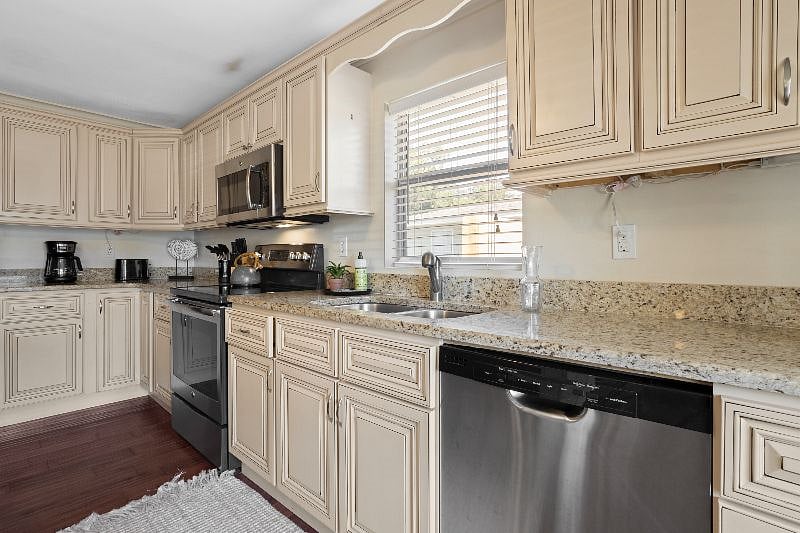 Stainless steel appliances with electric stovetop. 