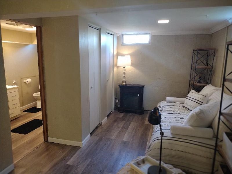 Lower Level Living Area Looking from Living Area to Daybed with Closet and Built in Dresser and Guest Bath