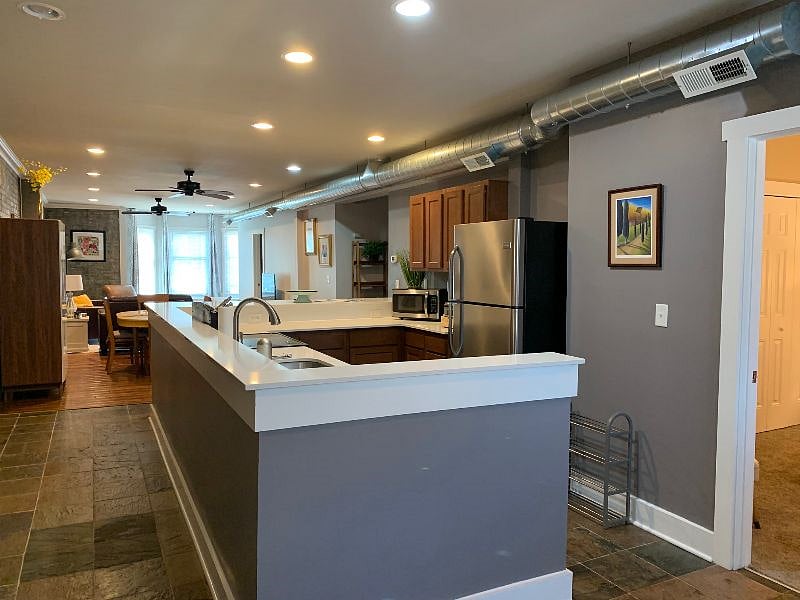 Open concept - view of kitchen, dining area, and living room with bay window seat. Opening to the right is the door for the primary bedroom.