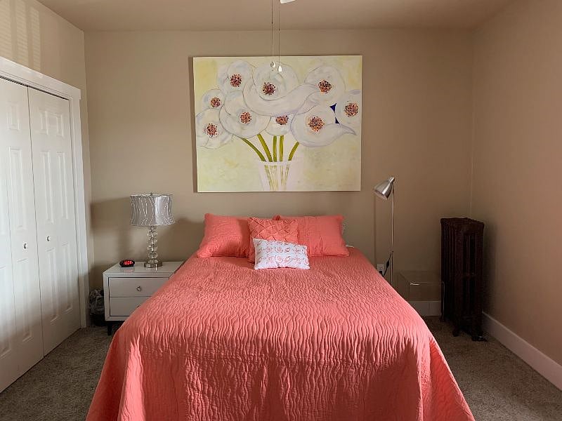 Primary bedroom with queen bed, nightstand, dresser (not in pic), closet, window (not in pic), and chair (not in pic).
