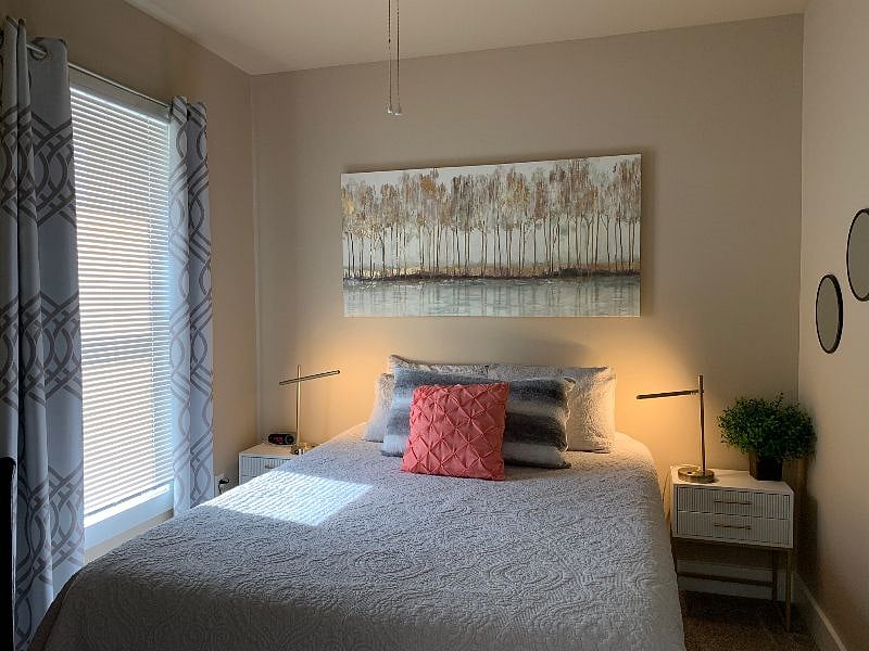 Second bedroom with 2 nightstands and queen bed. Ensuite bathroom and closet are to the right of this picture.
