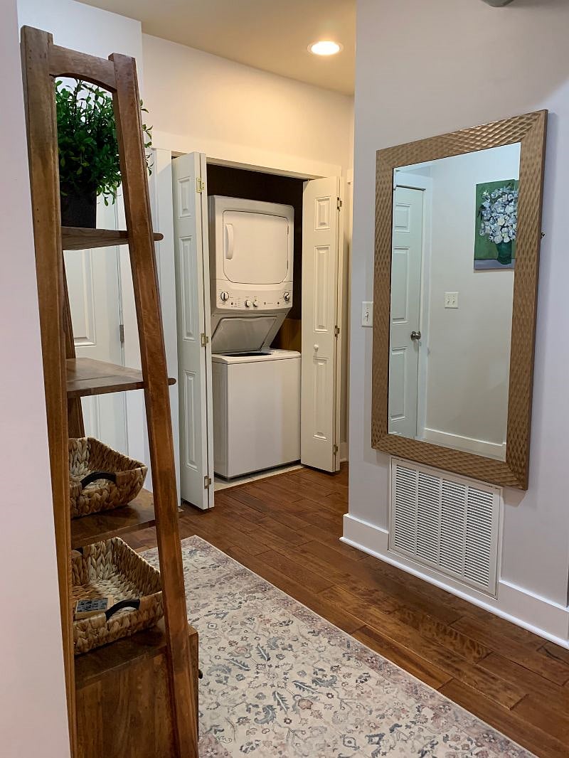 Stacked washer and dryer in closet near side entry door, just off the living room/breakfast bar area.