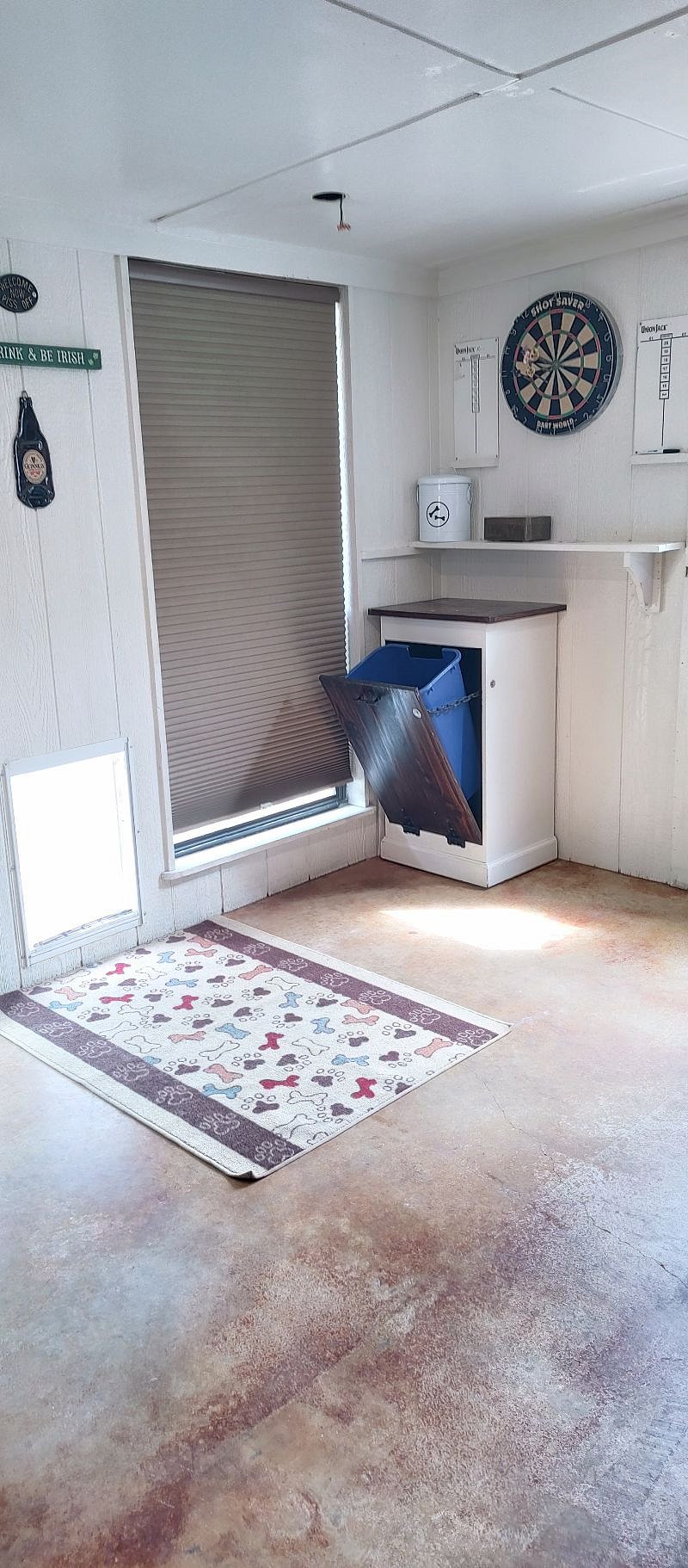 Large Dog door (open)  out to small fenced yard, recycle bin tucks away in this cabinet. 