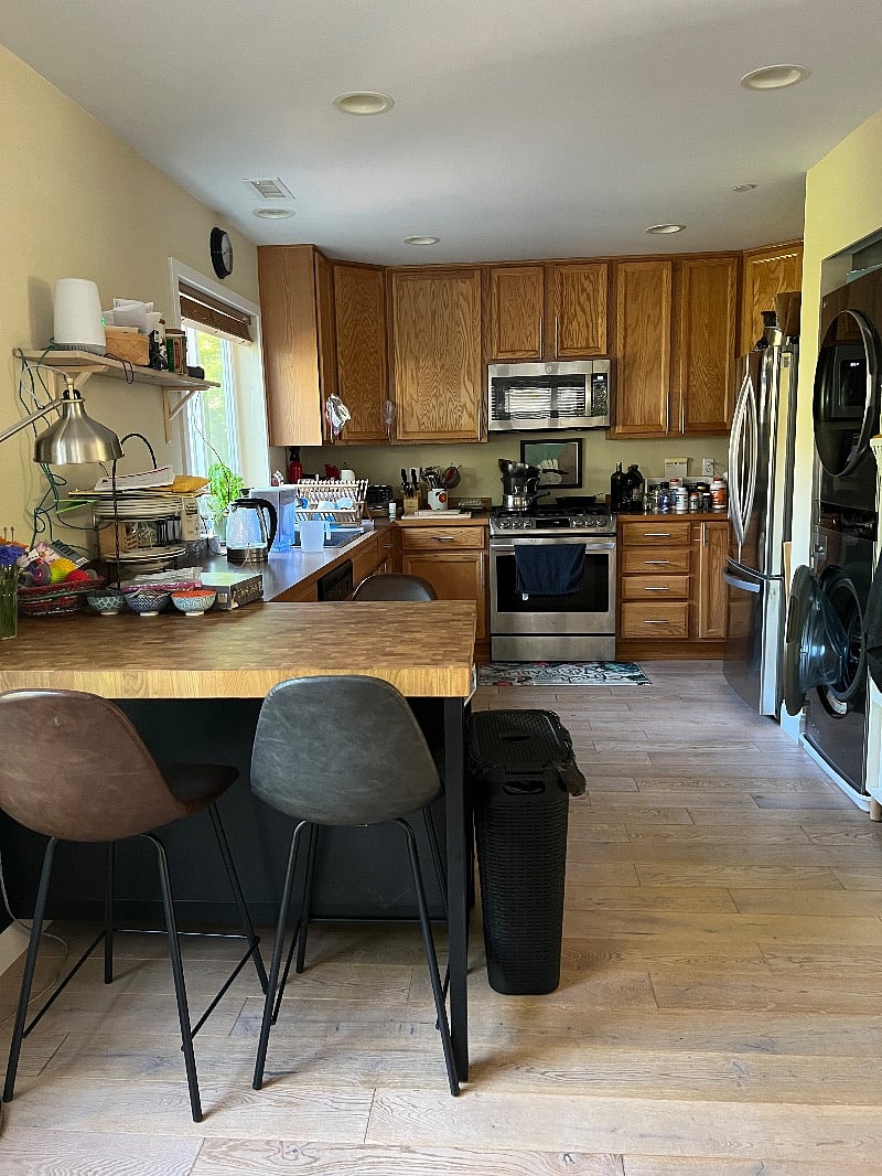 kitchen with microwave/air fryer, frig, stove, farmhouse sink, garbage disposal.