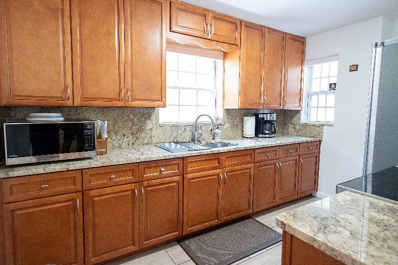 Complete Kitchen renovation with full sized stove and fridge with farmhouse sink.