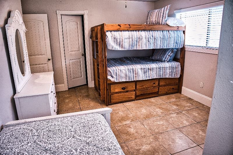 This room can sleep up to 6 guests with a full over full bunkbed that has a twin trundle underneath.  There is an additional twin bed and walk in closet as well.