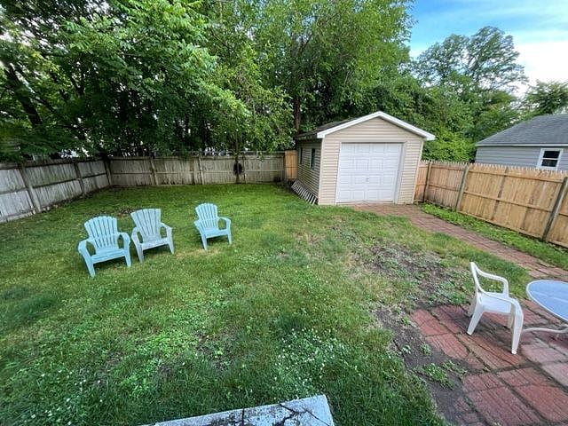 private backyard with adirondak chairs and patio set