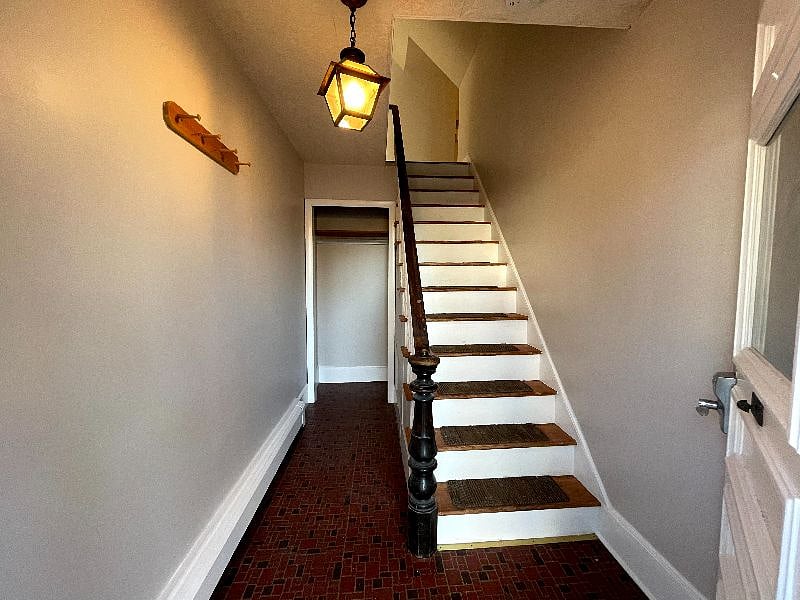 Private mud room at entry way. Stairs up to apartment