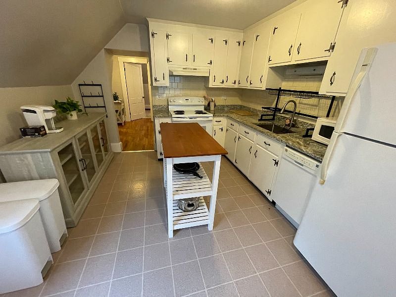 Kitchen has many cabinets for storage