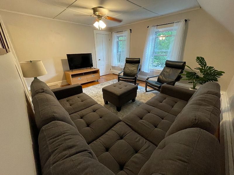Spacious living room with 2 large windows letting in lots of natural light.