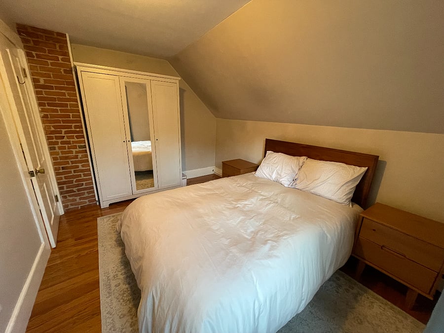 Bedroom with full size bed with wardrobe.