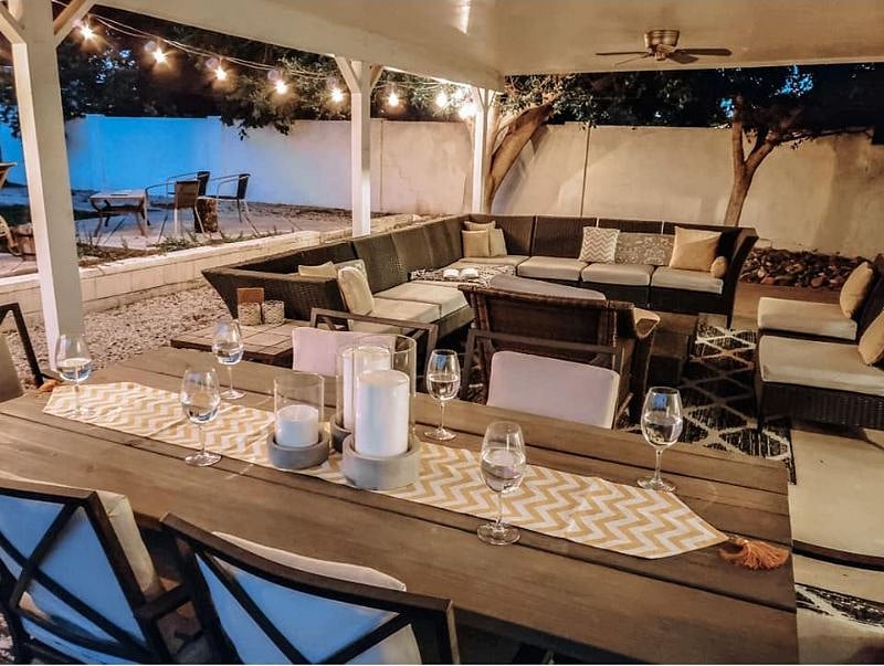 Back Patio includes a sectional that can seat 10, a large projector and screen with google chromecast, a dining table for 6 and a huge backyard, great for games. 