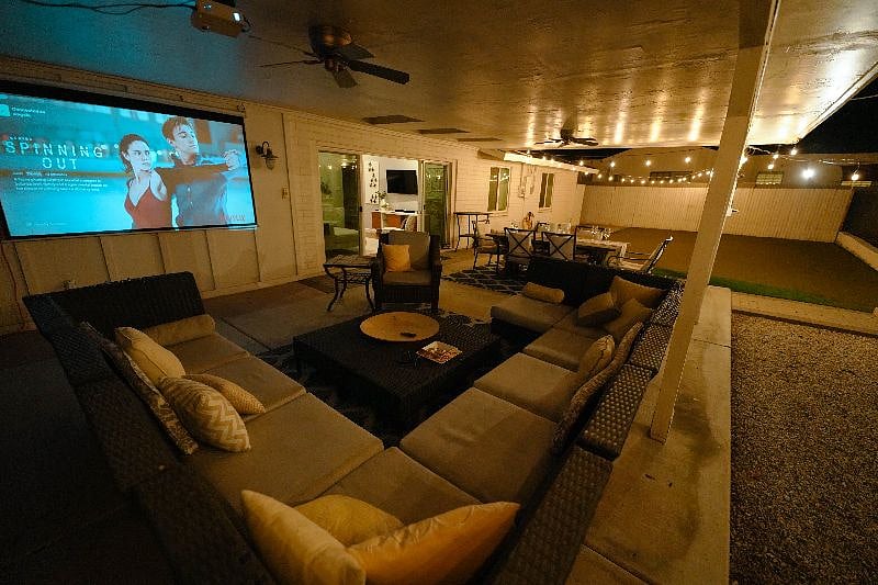 Back Patio includes a sectional that can seat 10, a large projector and screen with google chromecast, a dining table for 6 and a huge backyard, great for games. 
