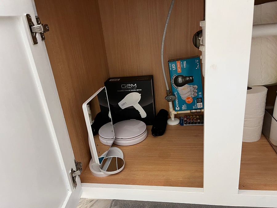 Vanity mirror, curling irons, hair dryer, and sewing kit