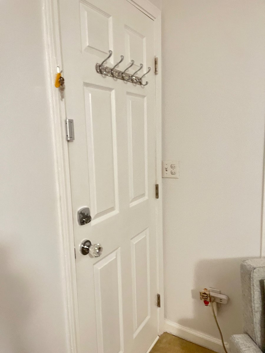 Hanging rack on back of door for coat, pocketbook, etc., hook right next to door for keys, Three locks on door for added security (knob lock, deadbolt with key, and inside latch hook)