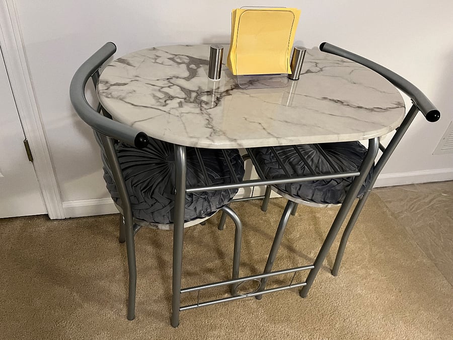 Small table to eat meals with complimentary napkins, salt and pepper