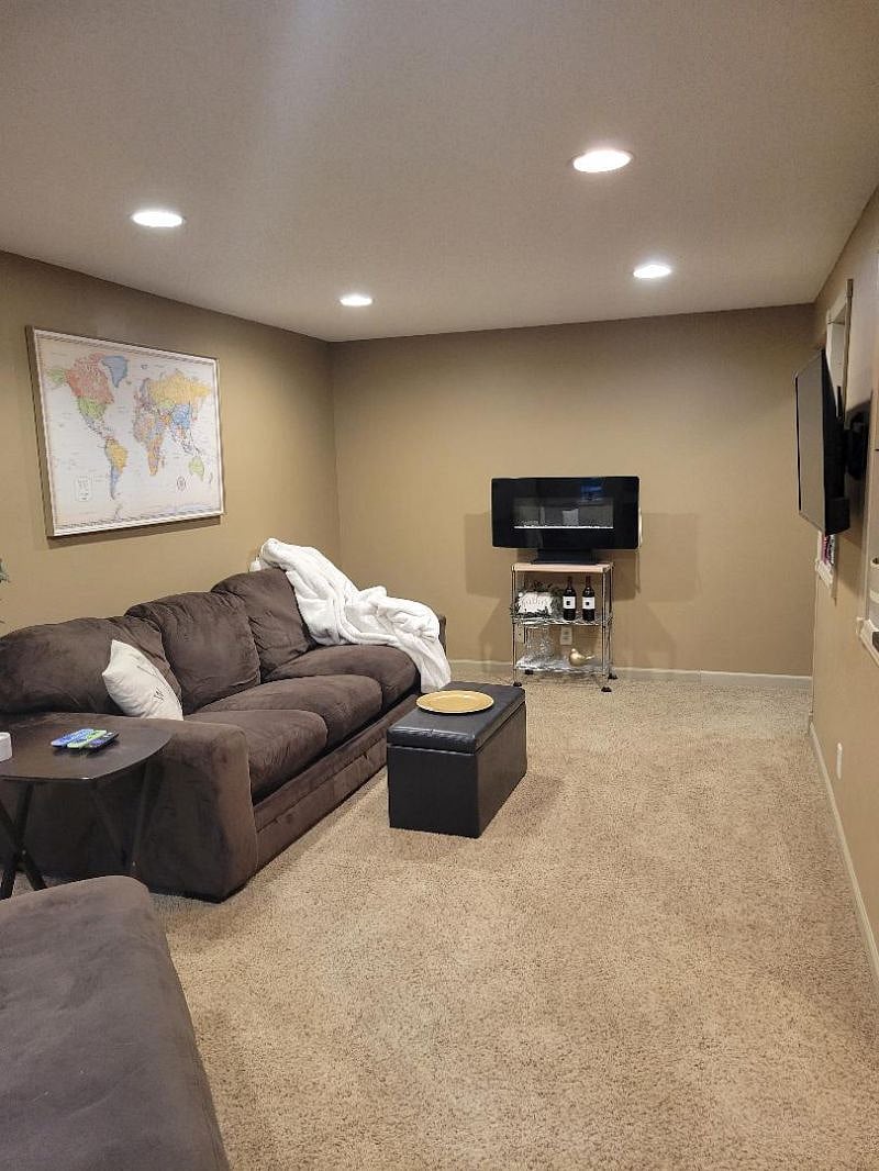 Living room right side - tv, games, fireplace, extra blanket storage