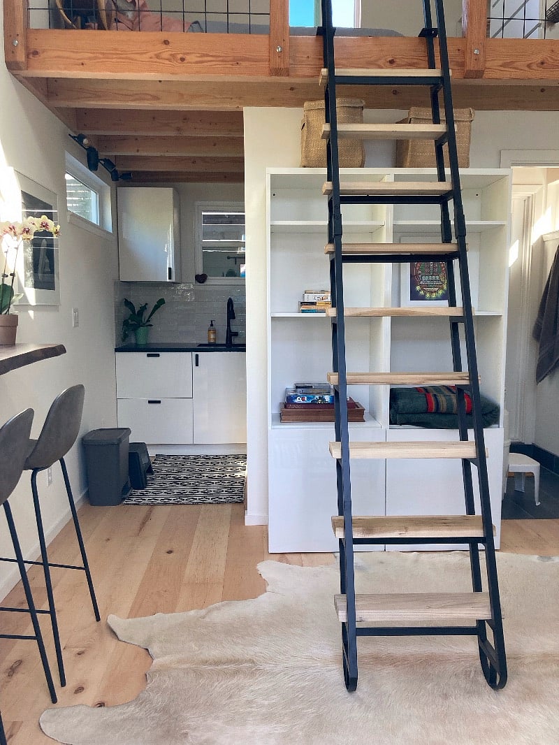 View of kitchen to left; bathroom to right; storage unit under staircase to loft