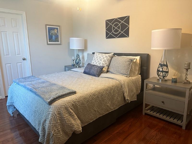 Comfortable guest bedroom featuring a high-quality memory foam mattress, plush bedding, and blackout curtains with sheers, allowing you to enjoy natural light during the day while maintaining privacy and complete darkness for restful sleep.