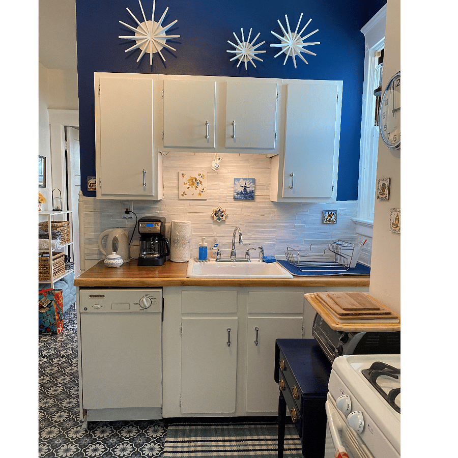 Kitchen with a small dishwasher. Quality and plentiful pots and pans, dishes, serving wear, knives, wineglasses, toaster oven, microwave, Ninja, and coffee pot (drip and Keurig) for use.