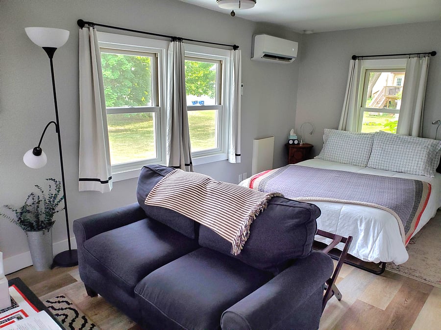 Queen bed and loveseat in the main room. 